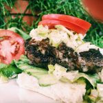 Grass-fed beef burger with slaw.