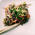 Soba salad with miso dressing, shredded carrots, mushrooms, edamame, radishes