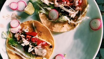 Classic baja fish tacos with cabbage, corn slaw, crema, and homemade pico de gallo