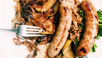 Autumnal meal of sausages, apples, and sauerkraut