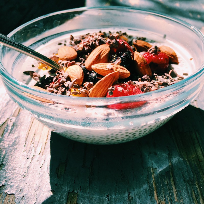 Super-powered chia pudding with mango, raspberry, and creamy coconut milk