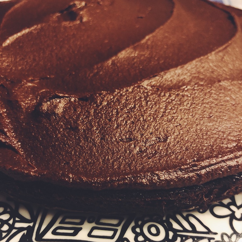 Flourless chocolate cake with a rich, chocolate fudge frosting is a decadent dessert. 